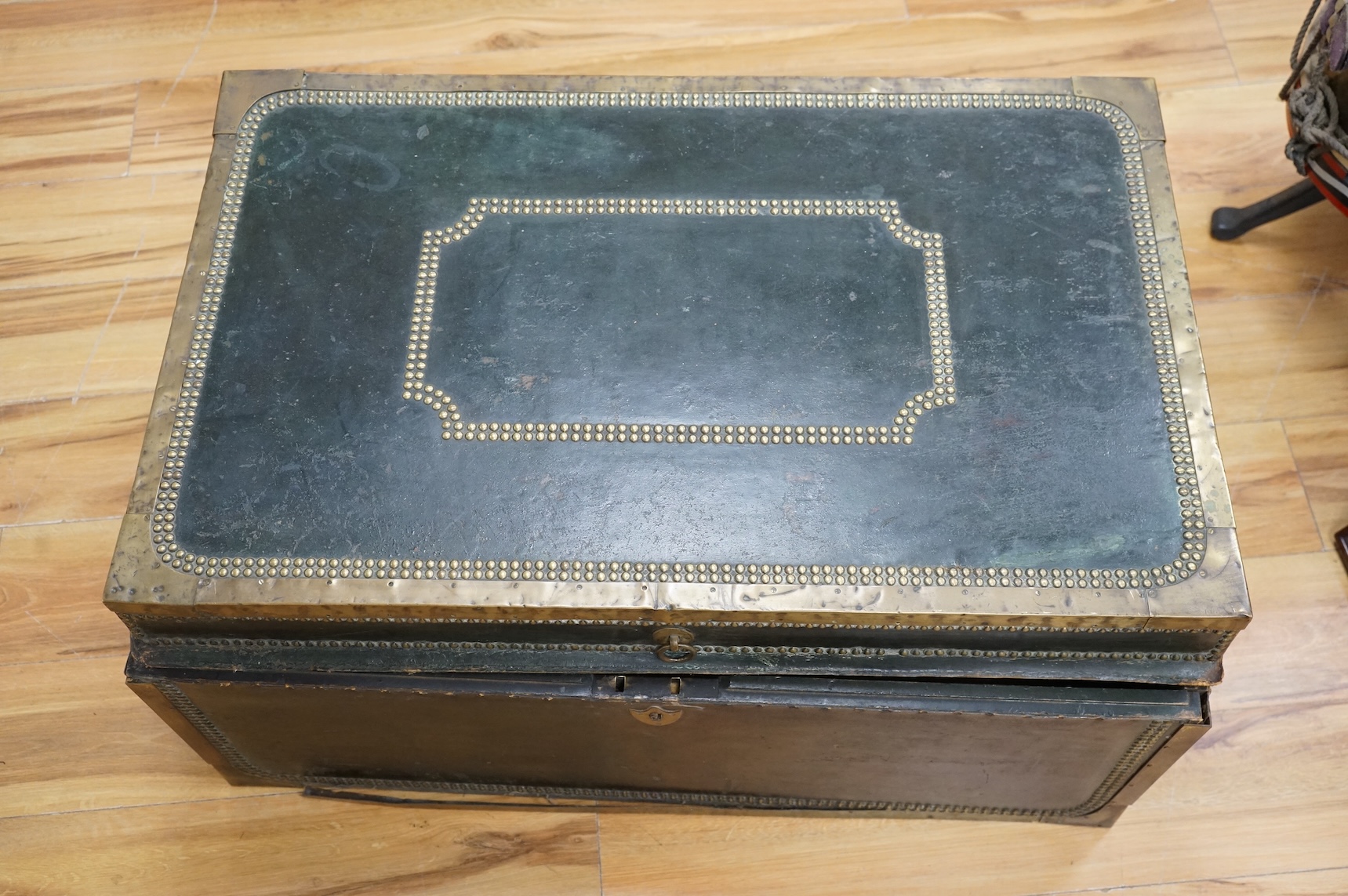 A 19th century Anglo Chinese camphor lined leather and brass studded trunk, lid detached, 85cm wide